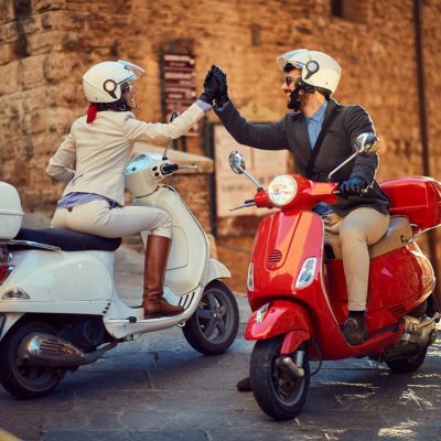 Young Italian Couple on Vespa Scooter. Bikers couple.